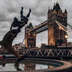 Girl with a Dolphin Fountain and Tower Bridge, London, England, UK.