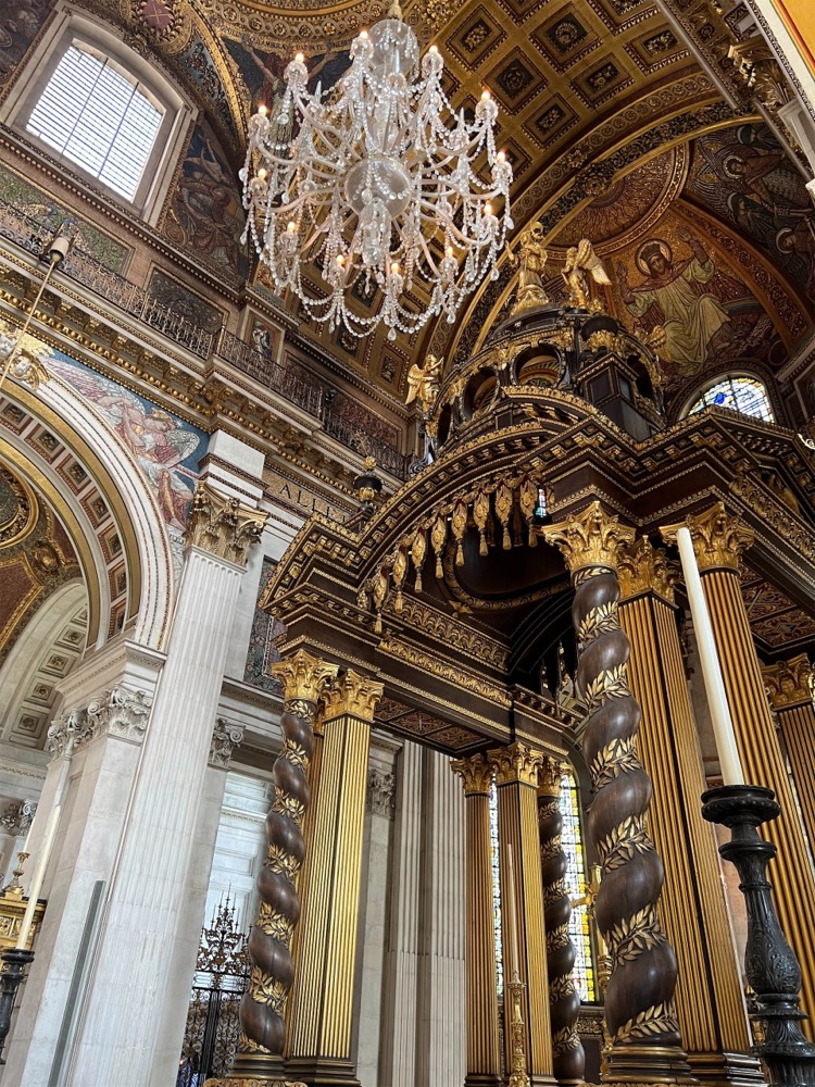 This is a photograph of the interior of St Paul's Cathedral in London England looking north east from the choir toward the high altar.