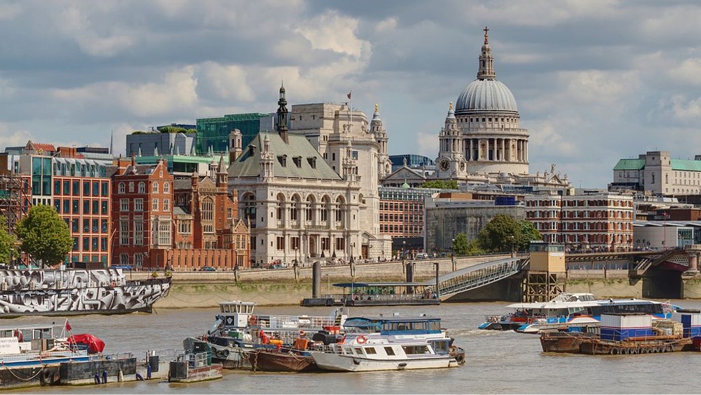 Cityscape of the northern bank of the River Thames & St Paul's Cathedral in London England.