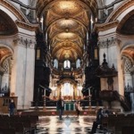 This is a photograph taken from the nave of St Paul's Cathedral in London England looking east toward the choir and high altar.